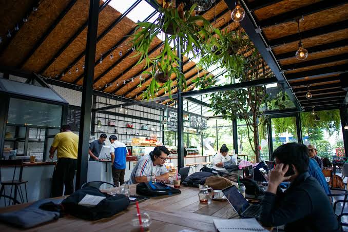 People working from a laptop-friendly cafe