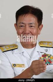 Japanese Admiral Akira Saito, Commander in Chief, Self Defense Fleet, JMSDF  speaks to Vice Admiral Karl Thomas, commander, Seventh Fleet at the JMSDF  Yokosuka Naval Base in Yokosuka, Kanagawa Prefecture