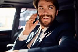 bearded man Driving a car trip luxury lifestyle success service rich