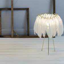 The warm light on the lamp will give you the feeling of coziness and comfort after a long tiring working day. White Feather Table Lamp Curiousegg