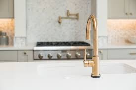 Searching for the best lights to match my delta champagne bronze faucets and hardware for my recent home project became a tricky task. Beautiful Delta Trinsic Kitchen Faucet In Champagne Bronze With White Quartz Countertop Trinsic Kitchen Faucet Kitchen Faucet Delta Trinsic Kitchen Faucet