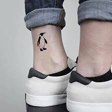 Amazon Com Penguin Temporary Fake Tattoo Sticker Set Of 2 Www Ohmytat Com Beauty With his singular one line drawing style, he creates minimalist art experiences through his own imaginary world. penguin temporary fake tattoo sticker
