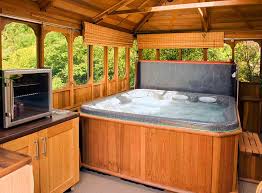 Hot tub in deck with storage cabinet.outdoor patios. Stunning Hot Tub Surround Ideas 2021 Checkatrade