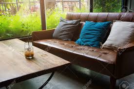 After seeing how gorgeous her living room looks now, you will never look at an old tub the same way again! Leather Sofa With A Glass Of Water On A Wooden Table In A Coffee Shop Stock Photo Picture And Royalty Free Image Image 85900475