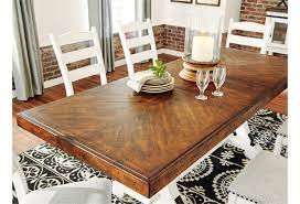 A dining room table is more than a place to eat, it's a place where friends and family gather. Signature Design By Ashley Valebeck D546 35 Two Tone Rectangular Dining Room Table With Leaf Northeast Factory Direct Dining Tables