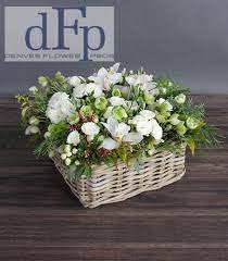 A fresh flower basket arrangement is an ideal gift for someone with limited space or from a friend wishing to send traditional display rather than a contemporary bouquet. The White And Green Flower Basket Arrangement By Denver Flower Pros