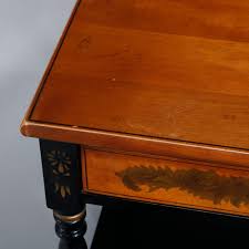 A distressed barnwood finish gives a timeworn look enhancing its rustic character. Vintage Hitchcock Stenciled And Gilt Ebonized Two Drawer Side Table Circa 1950 At 1stdibs