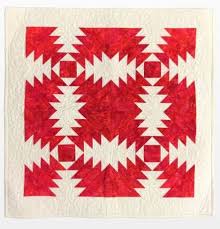 This nine patch log cabin block is 18 inches square and in different shades of blue. Log Cabin Quilts The Pioneering Spirit Of America