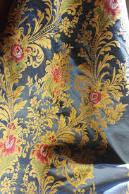 For instance, brocade fabric which is made out of silk material. Italian Silk Blend Blue Brocade Fabric With Gold Floral Pattern And Red Roses Contemporary Production Based On Ancient 17th Century Design