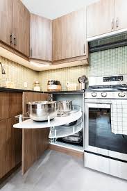 A kitchen that includes a stainless steel appliance package (stove, microwave, refrigerator and dishwasher) with custom kitchen cabinets and granite counter tops. A Kitchen Gets A New Layout In Flushing Queens