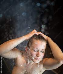 Pretty,young woman taking a long hot shower in a modern bathroom Stock  Photo | Adobe Stock
