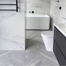 Those Tiles We Can T Get Enough Of The Matte Tile Craze And The Dilorenze Terra Gr White Marble Bathrooms Herringbone Tile Floors Trendy Bathroom Tiles