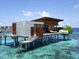 Entire neigborhood of homes built on stilts over the water in tropical area. Modern Beach House Over Water Novocom Top