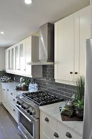 I used a white caulk on those, so they wouldn't stand out as much and need to go back and add a bit more white to them. Ice Gray Glass Subway Tile White Kitchen Backsplash Kitchen Remodel Kitchen Design