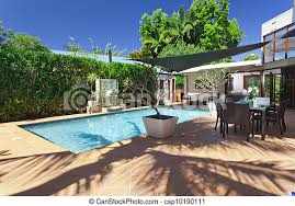 The spill water goes into a hidden trough under the. Modern Backyard With Swimming Pool And Entertaining Area In Australian Mansion Canstock