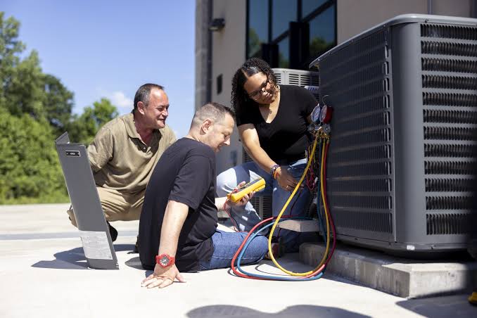 AC technician repairing an air conditioning unit