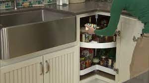 Installing a corner sink with a corner base cabinet can help you save countertop space. Corner Kitchen Cabinet Solutions