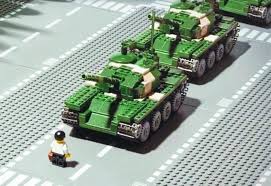 There is another picture that is street level with tank man in the background, and the person we see ride up on the bike is in that picture and to me looks to be civilian. Tiananmen Square Tank Man Lego