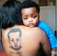 Some parenting decisions can be reversed; Excited Mom Tattoos Her Son S Face On Her Back Would You Do This For Your Child Photos Gistmania