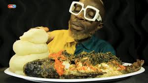 Watch Omonla Eat Fufu, Efo Riro (Spinach Soup), & Spicy Tilapia Fish