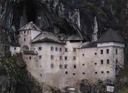 Predjama Castle Built Into The Side Of A Mountain In Slovenia Castle Pictures Castle Postojna