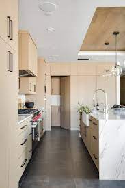 White Oak Kitchen Cabinets With Waterfall Marble Island Design By Chad Mellon White Oak Kitchen White Oak Kitchen Cabinets Oak Kitchen Cabinets