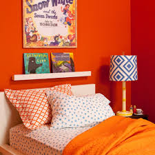 Here, crisp white walls provide a blank canvas that lets orange and pink accents shine. Decorating With Orange Sunset Magazine