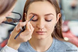 young beautiful apply makeup on a