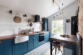 This is a bright kitchen due to its high white coffered ceiling paired with a light hardwood flooring and white pendant lights that brighten up the white countertop and gives a sheen to the stainless steel appliances against the gray cabinets. Black Kitchen Appliances Dark And Bold Additions For Every Kitchen