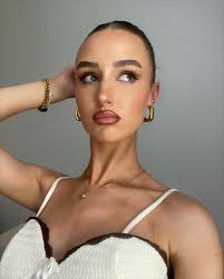 A slicked-back bun w/ gold hoops never fails