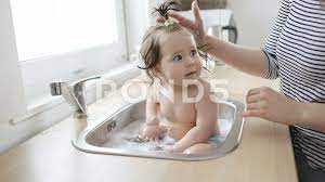 Browse 144 baby bath sink stock photos and images available, or start a new search to explore more stock photos and images. Baby Taking Bath In Kitchen Sink Stock Video Pond5