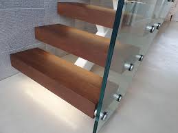 Suspended steps made in solid wood for contemporary and minimal environments, designed to confer cantilever with recesses arranged to receive the steel structure fixed to the wall. Floating Cantilever Staircases South Coast Steel Sussex Architectural Fabricators