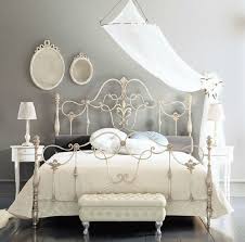 With a wrought iron bed, your bedroom immediately radiates a the bed is only the start of your decorating journey. Fancy Wrought Rod Iron Beds Curved With Silver Color And Wall Mounted Mirror Also Small White Table And White La White Iron Beds Iron Bed Frame Bedroom Vintage