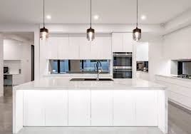 An excellent way to complement this design is to add in a dash of wood or metal. Modern White Kitchen With Waterfall Island White Modern Kitchen Modern Kitchen Cabinet Design Modern Kitchen Cabinets