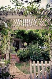 White Fence With Plant Overgrowth Landscaping Network Calimesa Ca Backyard Pergola White Pergola Dream Garden