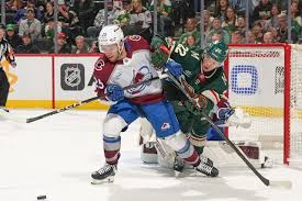 Intense hockey match between Colorado Avalanche and Minnesota Wild