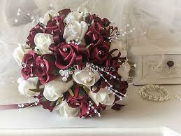 To bring your wedding floral dreams to life, begin with a rough idea of your wedding theme and colour scheme, the style of bouquets you are after, and your estimated flower budget. Wedding Flowers Brides Round Bouquet Burgundy Maroon And Ivory Crystals Pearls Sues Flowers Of York