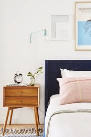 A Navy Blue Suede Headboard With Beige Sheets A Pink Pillow And A Mod Wood Side Table Eclectic Bedroom Bedroom Design Home Decor Bedroom Velvety navy blue headboards enhance a classic setting, while striped upholstery makes a fun statement.