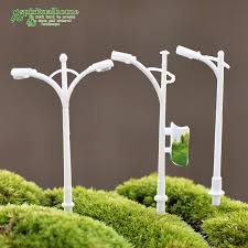 Rocks make the base for this fairy garden in an old wood bucket. Street Lamp Miniature Fairy Garden Home Houses Decoration Mini Craft Micro Landscaping Decor Diy Accessories Accessories Decor Accessories Creativeaccessories Nissan Aliexpress
