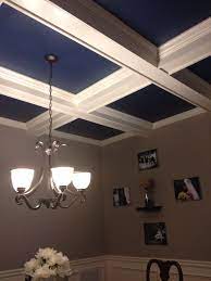 It instantly becomes the focal point of an otherwise plain room. Navy Blue Paint Inside Coffer Ceiling In Dining Room Beautiful Family Room Paint Dining Room Paint Colors Dining Room Ceiling