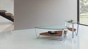 Clear/black large oval glass coffee table a swooping, arched base lends a modern touch a swooping, arched base lends a modern touch to this elegant oval coffee table, perfect for adding space in front of a sofa or as the center of a large seating arrangement. Dino 1347 Modern Glass Coffee Table Bdi Furniture