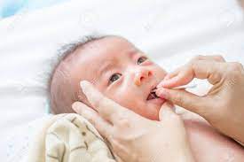 You may gently rub a soft cloth dipped in lukewarm water over the baby's tongue to clean it. Asian Newborn Baby Cleaning Tongue Cheek Bulge And Mouth After Stock Photo Picture And Royalty Free Image Image 88635495