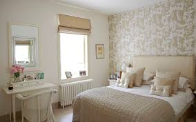A neutral bedroom with a navy and white floral print wall that adds catchiness and makes the space bold. Neutral Wallpaper Houzz