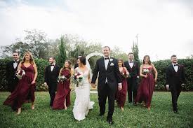 Outdoor Garden Wedding Party Portrait Bride With White Red Rose And Greenery Bouq Red Bridesmaid Dresses Outdoor Wedding Photography Enchanted Garden Wedding