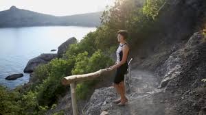 Young woman is staying on Golitsyn trail. Cute girl is posing on ...