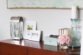 A simple, light console table with one or two accessories can draw attention to them, highlighting their importance. The Right Way To Create A Picture Frame Display The Diy Playbook