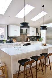 A modern kitchen island in black and white of an ikea kallax shelf. Ikea Kitchen Midcentury Modern Kitchen White Kitchen Vaulted Ceiling Waterfall Island White Modern Kitchen Modern Kitchen Mid Century Modern Kitchen