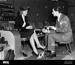 1930s Shoe Salesman Helping Woman Try On Pair High Heels In Retail Shoe Store Stock Photo Alamy