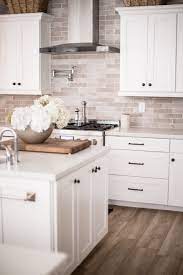 The addition of small open shelves beside the sink is both stylistic and a great choice for providing extra storage space in a small kitchen. White Kitchen Cabinets With Black Hardware And Hinges Decorkeun