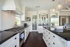 The black and the white are the two primary colors, and the dark wood flooring acts as an accent color between the cabinets and countertops. 36 Inspiring Kitchens With White Cabinets And Dark Granite Pictures Home Stratosphere